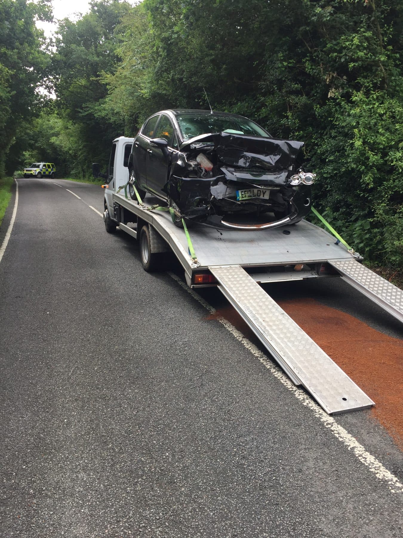 Damaged Ford Fiesta loaded on recovery truck